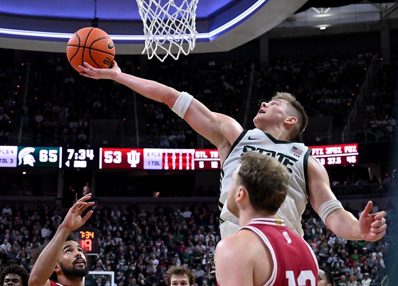 Jan 13, 2026; East Lansing, Michigan, USA;  Michigan State Spartans forward Jaxon Kohler (0) controls an offensive rebound against the Indiana Hoosiers during the second half at Jack Breslin Student Events Center. Mandatory Credit: Dale Young-Imagn Images