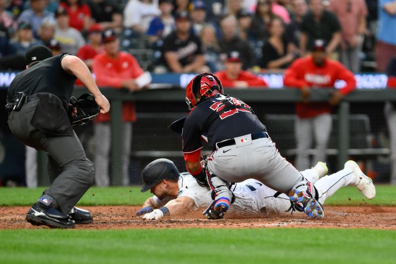 Jun 27, 2023; Seattle, Washington, USA; Seattle Mariners left fielder Jarred Kelenic (10) slides past Washington Nationals catcher Keibert Ruiz (20) to score a run during the seventh inning at T-Mobile Park. Mandatory Credit: Steven Bisig-USA TODAY Sports