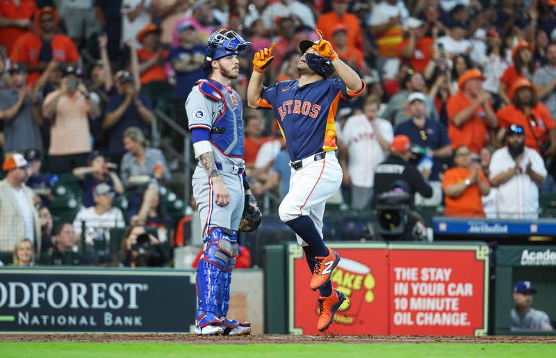 Apr 14, 2024; Houston, Texas, USA; Texas Rangers catcher Jonah Heim (28) looks on as Houston Astros second baseman Jose Altuve (27) scores a run after hitting a home run during the third inning at Minute Maid Park. Mandatory Credit: Troy Taormina-USA TODAY Sports