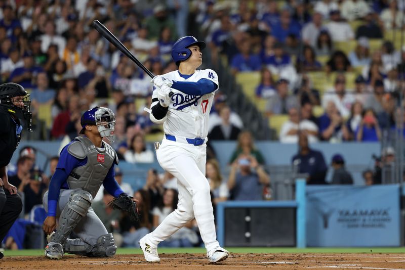 Sep 11, 2024; Los Angeles, California, USA;  Los Angeles Dodgers designated hitter Shohei Ohtani (17) hits a home run during the first inning against the Chicago Cubs at Dodger Stadium. Mandatory Credit: Kiyoshi Mio-Imagn Images