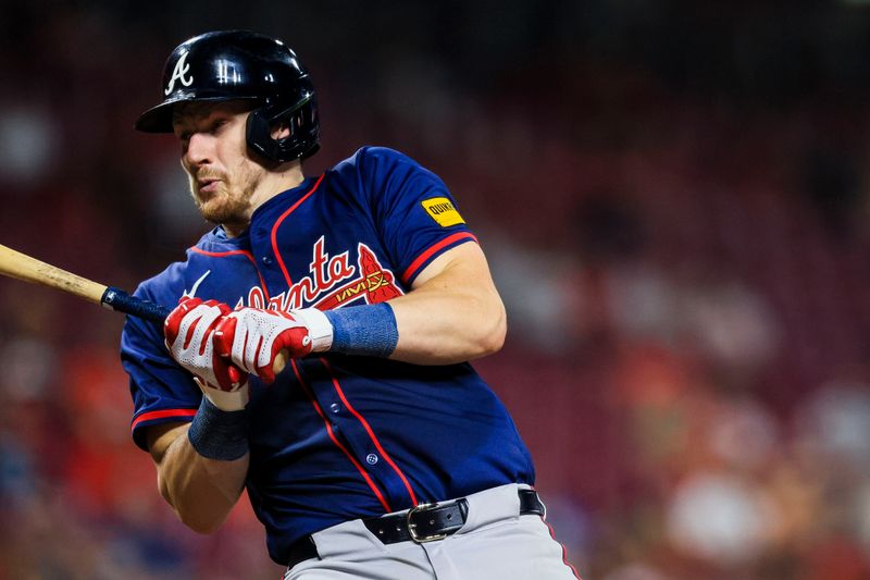 Sep 18, 2024; Cincinnati, Ohio, USA; Atlanta Braves catcher Sean Murphy (12) dodges a wild pitch in the seventh inning against the Cincinnati Reds at Great American Ball Park. Mandatory Credit: Katie Stratman-Imagn Images