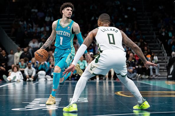 CHARLOTTE, NORTH CAROLINA - NOVEMBER 17: Damian Lillard #0 of the Milwaukee Bucks guards LaMelo Ball #1 of the Charlotte Hornets in the third quarter during an NBA In-Season Tournament game at Spectrum Center on November 17, 2023 in Charlotte, North Carolina. NOTE TO USER: User expressly acknowledges and agrees that, by downloading and or using this photograph, User is consenting to the terms and conditions of the Getty Images License Agreement. (Photo by Jacob Kupferman/Getty Images)