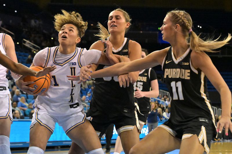 Jan 21, 2026; Los Angeles, California, USA;  UCLA Bruins guard Kiki Rice (1) is defended under the basket by guard Madison Layden-Zay (33) and Purdue Boilermakers guard McKenna Layden (11) in the first half at Pauley Pavilion presented by Wescom Financial. Mandatory Credit: Jayne Kamin-Oncea-Imagn Images