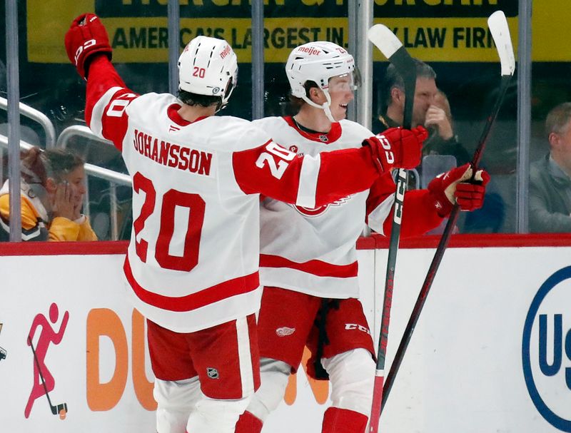 Oct 1, 2024; Pittsburgh, Pennsylvania, USA;  Detroit Red Wings center Nate Danielson (right) celebrates with defenseman Albert Johansson (20) after scoring a goal against the Pittsburgh Penguins during the third period at PPG Paints Arena. Detroit won 2-1. Mandatory Credit: Charles LeClaire-Imagn Images