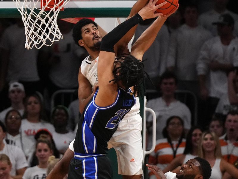 Feb 6, 2023; Coral Gables, Florida, USA; Miami Hurricanes guard Harlond Beverly (5) blocks the shot of Duke Blue Devils center Christian Reeves (21) during the second half at Watsco Center. Mandatory Credit: Jasen Vinlove-USA TODAY Sports