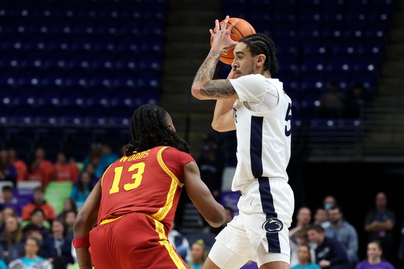 Feb 8, 2026; University Park, Pennsylvania, USA; Penn State Nittany Lions guard Freddie Dilione V (5) holds the ball as Southern California Trojans guard Kam Woods (13) defends during the first half at Bryce Jordan Center. Mandatory Credit: Matthew O'Haren-Imagn Images