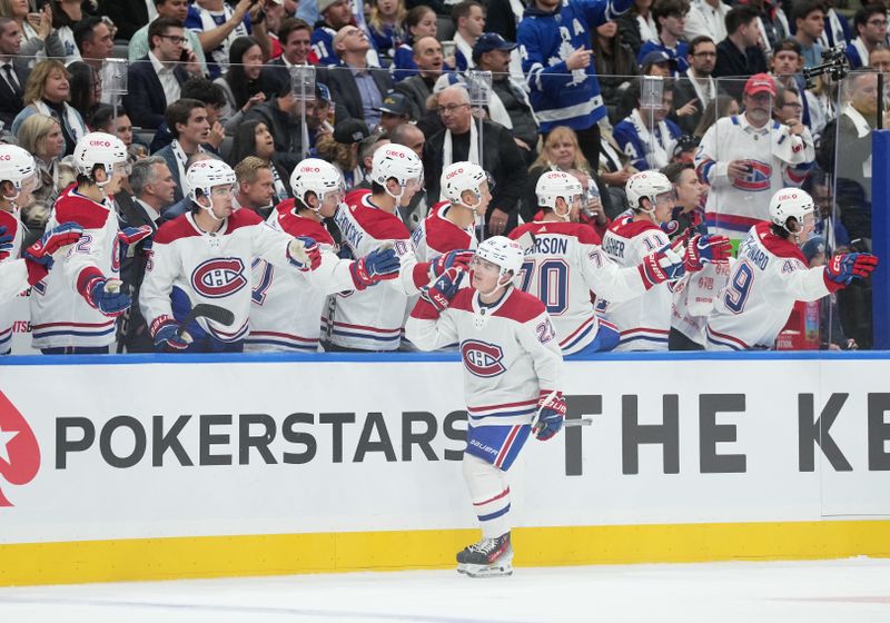 Oct 11, 2023; Toronto, Ontario, CAN; Montreal Canadiens right wing Cole Caufield (22) celebrates at the bench after scoring a goal against the Toronto Maple Leafs during the third period at Scotiabank Arena. Mandatory Credit: Nick Turchiaro-USA TODAY Sports