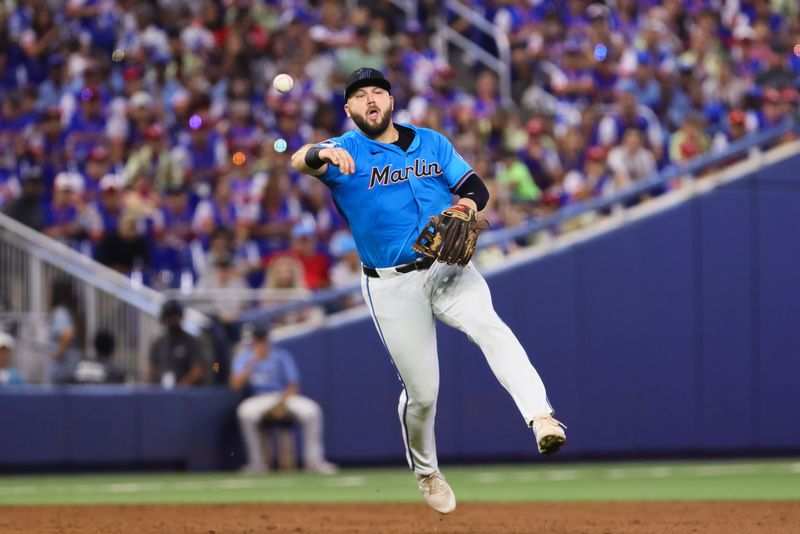 Jul 21, 2024; Miami, Florida, USA; Miami Marlins third baseman Jake Burger (36) throws to first base to retire New York Mets shortstop Francisco Lindor (not pictured) during the third inning at loanDepot Park. Mandatory Credit: Sam Navarro-USA TODAY Sports