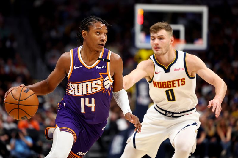 DENVER, COLORADO - OCTOBER 13: TyTy Washington Jr. #14 of the Phoenix Suns drives against Christian Braun #0 of the Denver Nuggets in the second half at Ball Arena on October 13, 2024 in Denver, Colorado. NOTE TO USER: User expressly acknowledges and agrees that, by downloading and/or using this Photograph, user is consenting to the terms and conditions of the Getty Images License Agreement. (Photo by Jamie Schwaberow/Getty Images)