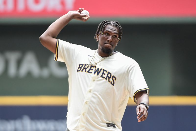 Aug 9, 2023; Milwaukee, Wisconsin, USA;  Milwaukee native and Golden State Warriors forward Kevon Looney throws the ceremonial first pitch before game between the Milwaukee Brewers and Colorado Rockies at American Family Field. Mandatory Credit: Benny Sieu-USA TODAY Sports