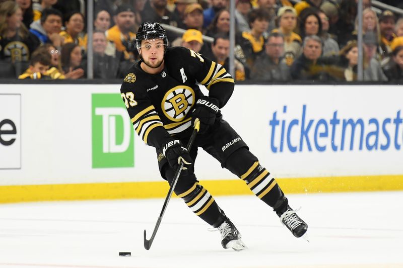 May 12, 2024; Boston, Massachusetts, USA; Boston Bruins defenseman Charlie McAvoy (73) controls the puck during the first period in game four of the second round of the 2024 Stanley Cup Playoffs against the Florida Panthers at TD Garden. Mandatory Credit: Bob DeChiara-USA TODAY Sports