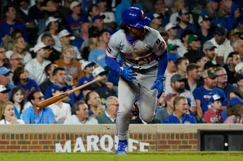Sep 23, 2025; Chicago, Illinois, USA; New York Mets shortstop Francisco Lindor (12) hits a one run single against the Chicago Cubs during the sixth inning at Wrigley Field. Mandatory Credit: David Banks-Imagn Images