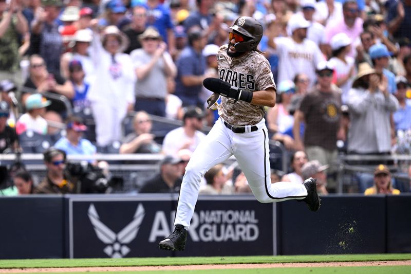 Jul 30, 2023; San Diego, California, USA; San Diego Padres right fielder Fernando Tatis (23) advances home to score a run against the Texas Rangers during the fourth inning at Petco Park. Mandatory Credit: Orlando Ramirez-USA TODAY Sports