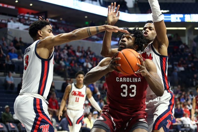 Feb 11, 2023; Oxford, Mississippi, USA; South Carolina Gamecocks forward Josh Gray (33) shoots as Mississippi Rebels forward Myles Burns (3) and forward Theo Akwuba (10) defend during the first half at The Sandy and John Black Pavilion at Ole Miss. Mandatory Credit: Petre Thomas-USA TODAY Sports