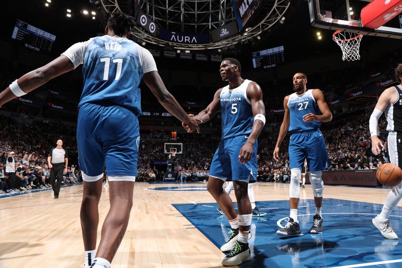 MINNEAPOLIS, MN -  FEBRUARY 27: Naz Reid #11 of the Minnesota Timberwolves and Anthony Edwards #5 of the Minnesota Timberwolves high five during the game against the San Antonio Spurs on February 27, 2024 at Target Center in Minneapolis, Minnesota. NOTE TO USER: User expressly acknowledges and agrees that, by downloading and or using this Photograph, user is consenting to the terms and conditions of the Getty Images License Agreement. Mandatory Copyright Notice: Copyright 2024 NBAE (Photo by David Sherman/NBAE via Getty Images)