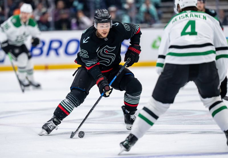 Nov 26, 2025; Seattle, Washington, USA; Seattle Kraken defenseman Brandon Montour (62) skates against Dallas Stars defenseman Miro Heiskanen (4) during the second period at Climate Pledge Arena. Mandatory Credit: Stephen Brashear-Imagn Images