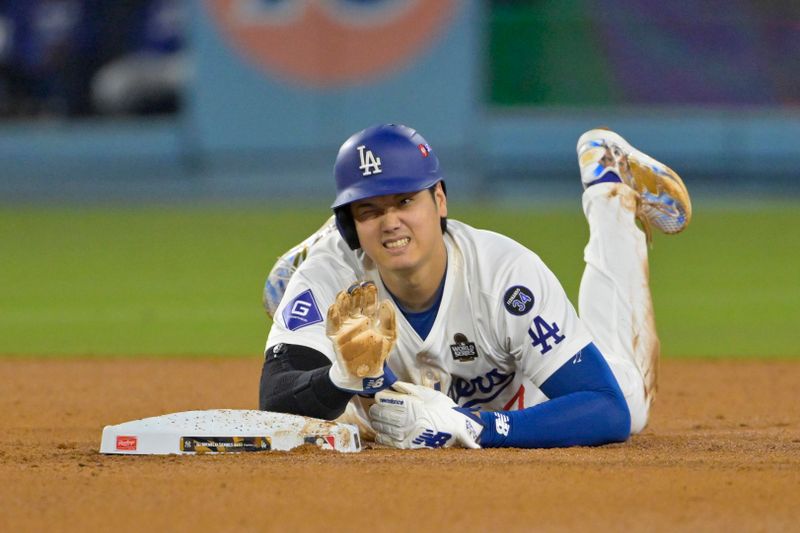 Oct 26, 2024; Los Angeles, California, USA; Los Angeles Dodgers designated hitter Shohei Ohtani (17) reacts at second base after an apparent injury in the seventh inning against the New York Yankees during game two of the 2024 MLB World Series at Dodger Stadium. Mandatory Credit: Jayne Kamin-Oncea-Imagn Images