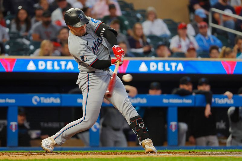 Sep 24, 2024; Minneapolis, Minnesota, USA; Miami Marlins catcher Nick Fortes (4) hits an RBI single against the Minnesota Twins in the second inning at Target Field. Mandatory Credit: Bruce Kluckhohn-Imagn Images