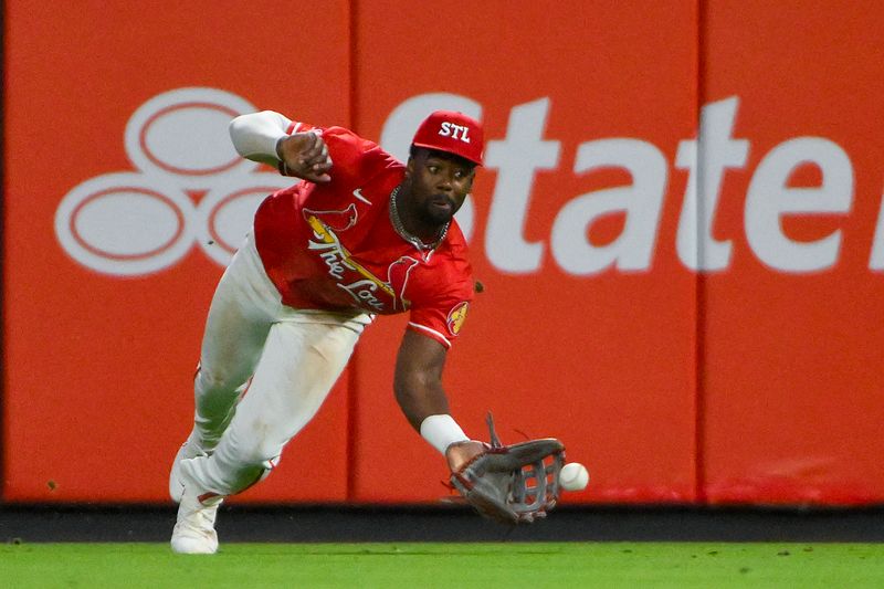 Apr 25, 2025; St. Louis, Missouri, USA;  St. Louis Cardinals right fielder Jordan Walker (18) dives but is unable to catch a single by Milwaukee Brewers left fielder Jackson Chourio (not pictured) during the eighth inning at Busch Stadium. Mandatory Credit: Jeff Curry-Imagn Images