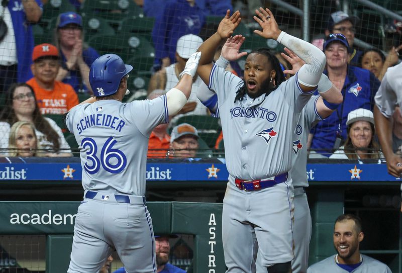Apr 2, 2024; Houston, Texas, USA; Toronto Blue Jays left fielder Davis Schneider (36) celebrates with first baseman Vladimir Guerrero Jr. (27) after hitting a home run during the ninth inning against the Houston Astros at Minute Maid Park. Mandatory Credit: Troy Taormina-USA TODAY Sports