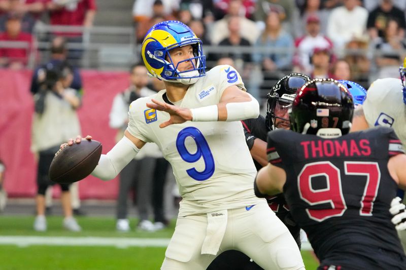 Los Angeles Rams quarterback Matthew Stafford (9) throws the football against the Arizona Cardinals during the first half of an NFL football game, Sunday, Nov. 26, 2023, in Glendale, Ariz. (AP Photo/Rick Scuteri)