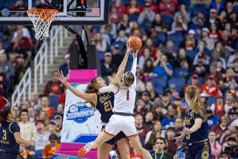 Mar 9, 2024; Greensboro, NC, USA; Notre Dame Fighting Irish forward Maddy Westbeld (21) blocks the attempted sho of Virginia Tech Hokies guard Carleigh Wenzel (1) during the second half at Greensboro Coliseum. Mandatory Credit: David Yeazell-USA TODAY Sports