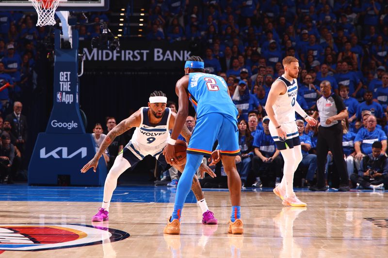 OKLAHOMA CITY, OK - MAY 22: Shai Gilgeous-Alexander #2 of the Oklahoma City Thunder dribbles the ball while Nickeil Alexander-Walker #9 of the Minnesota Timberwolves plays defense during the game during Game Two of the Western Conference Finals on May 22, 2025 at Paycom Center in Oklahoma City, Oklahoma. NOTE TO USER: User expressly acknowledges and agrees that, by downloading and or using this photograph, User is consenting to the terms and conditions of the Getty Images License Agreement. Mandatory Copyright Notice: Copyright 2025 NBAE (Photo by Zach Beeker/NBAE via Getty Images)