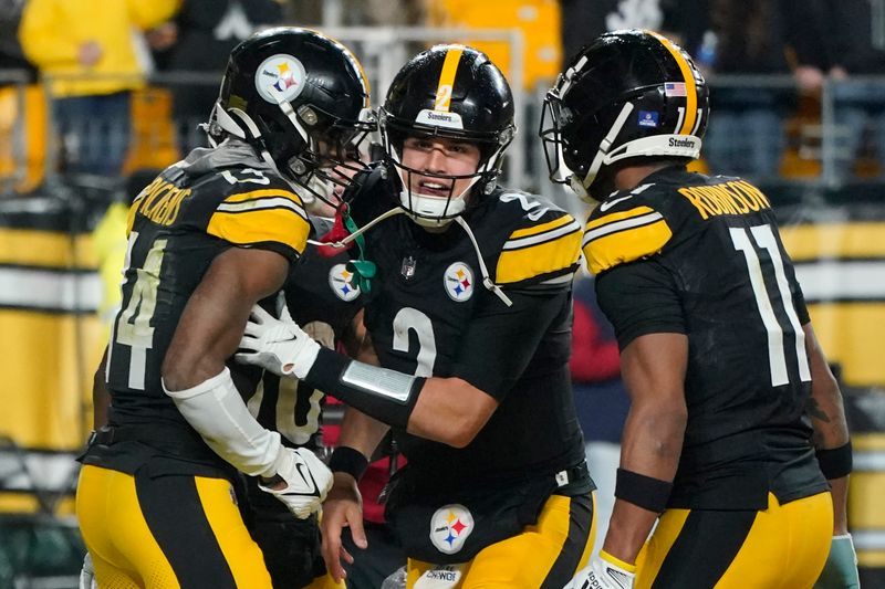 Pittsburgh Steelers quarterback Mason Rudolph (2) celebrates with wide receiver George Pickens, left, after the two connected for a touchdown during an NFL football game against the Cincinnati Bengals in Pittsburgh, Saturday Dec. 23, 2023. (AP Photo/Gene J. Puskar)