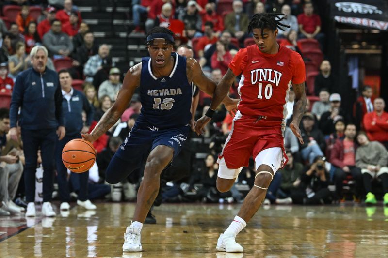 Jan 28, 2023; Las Vegas, Nevada, USA; Nevada Wolf Pack guard Kenan Blackshear (13) dribbles the ball against UNLV Runnin' Rebels guard Keshon Gilbert (10) in the first half at Thomas & Mack Center. Mandatory Credit: Candice Ward-USA TODAY Sports