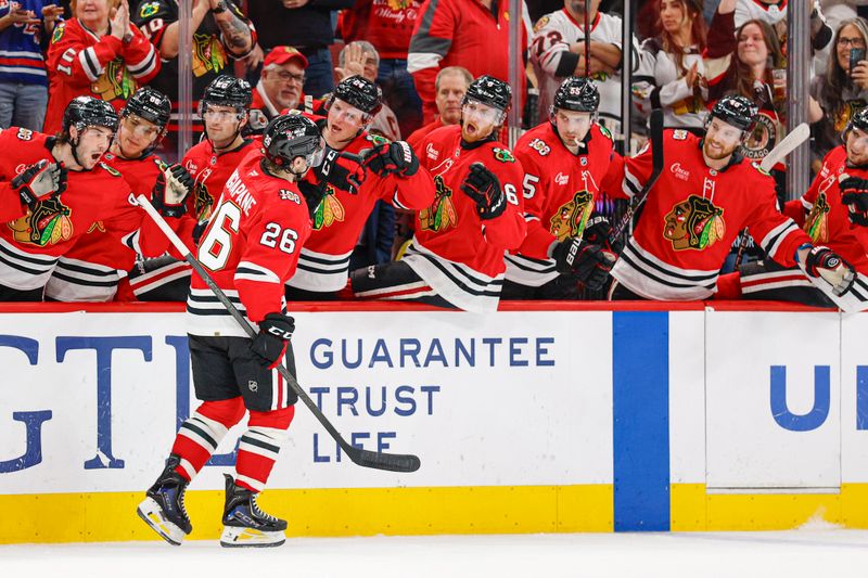 Mar 9, 2026; Chicago, Illinois, USA; Chicago Blackhawks left wing Andrew Mangiapane (26) celebrates with teammates after scoring against the Utah Mammoth during the first period at United Center. Mandatory Credit: Kamil Krzaczynski-Imagn Images