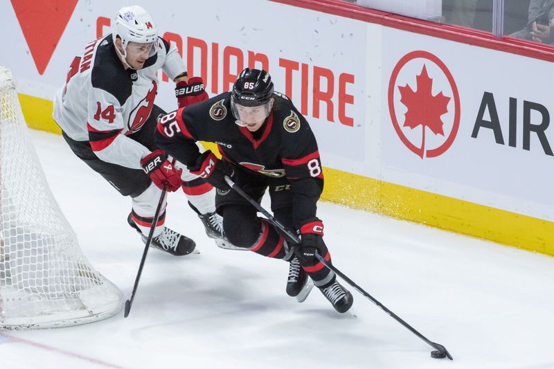 Dec 29, 2023; Ottawa, Ontario, CAN; Ottawa Senators defenseman Jake Batherson (85) skates with the puck in front of New Jersey Devils right wing Nathan Bastian (14) in the third period at the Canadian Tire Centre. Mandatory Credit: Marc DesRosiers-USA TODAY Sports