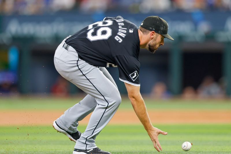 Jul 23, 2024; Arlington, Texas, USA; Chicago White Sox shortstop Paul DeJong (29) makes a bare hand pickup on a ground ball during the third inning against the Texas Rangers at Globe Life Field. Mandatory Credit: Andrew Dieb-USA TODAY Sports