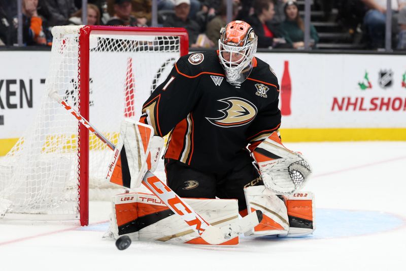 Dec 21, 2023; Anaheim, California, USA;  Anaheim Ducks goaltender Lukas Dostal (1) blocks a shot during the third period against the Calgary Flames at Honda Center. Mandatory Credit: Kiyoshi Mio-USA TODAY Sports