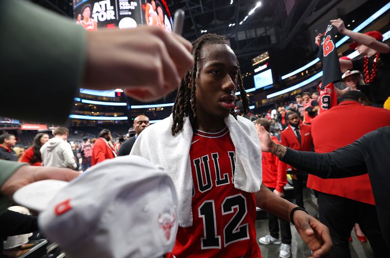 ATLANTA, GEORGIA - FEBRUARY 12:  Ayo Dosunmu #12 of the Chicago Bulls reacts after their 136-126 win over the Atlanta Hawks at State Farm Arena on February 12, 2024 in Atlanta, Georgia.  NOTE TO USER: User expressly acknowledges and agrees that, by downloading and/or using this photograph, user is consenting to the terms and conditions of the Getty Images License Agreement.  (Photo by Kevin C. Cox/Getty Images)