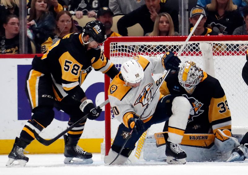 Apr 15, 2024; Pittsburgh, Pennsylvania, USA;  Pittsburgh Penguins defenseman Kris Letang (58) and goaltender Alex Nedeljkovic (39) defend the net against Nashville Predators center Colton Sissons (10) during the third period at PPG Paints Arena. Mandatory Credit: Charles LeClaire-USA TODAY Sports