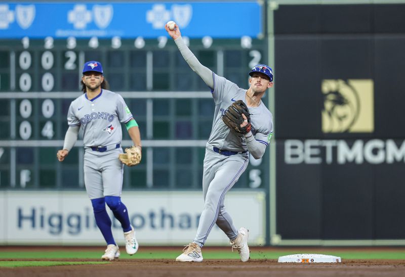 Apr 3, 2024; Houston, Texas, USA; Toronto Blue Jays second baseman Cavan Biggio (8) throws out a runner to complete a double play during the second inning against the Houston Astros at Minute Maid Park. Mandatory Credit: Troy Taormina-USA TODAY Sports