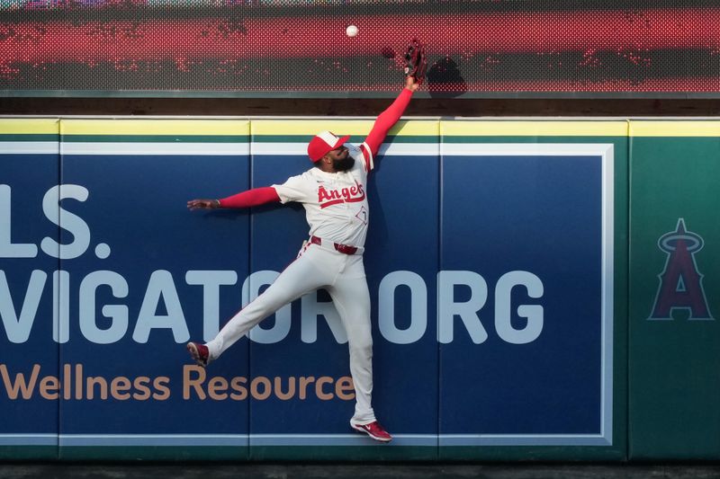 Jun 7, 2025; Anaheim, California, USA; Los Angeles Angels center fielder Jo Adell (7) attempts to catch a three-run home run by Seattle Mariners catcher Cal Raleigh (not pictured) in the first inning at Angel Stadium. Mandatory Credit: Kirby Lee-Imagn Images