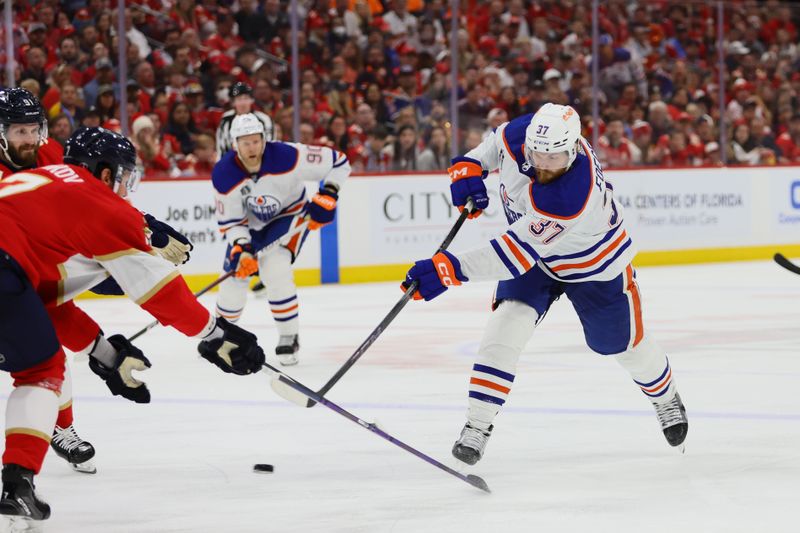 Jun 24, 2024; Sunrise, Florida, USA; Edmonton Oilers defenseman Cody Ceci (5) looks on after blocking a shot on net as Florida Panthers forward Aleksander Barkov (16) reaches for the puck during the third period in game seven of the 2024 Stanley Cup Final at Amerant Bank Arena. Mandatory Credit: Jim Rassol-USA TODAY Sports