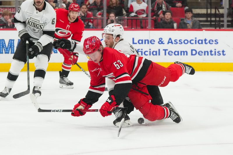 Feb 1, 2026; Raleigh, North Carolina, USA; Carolina Hurricanes right wing Jackson Blake (53) battle over the puck against Los Angeles Kings right wing Alex Laferriere (14) during the third period at Lenovo Center. Mandatory Credit: James Guillory-Imagn Images