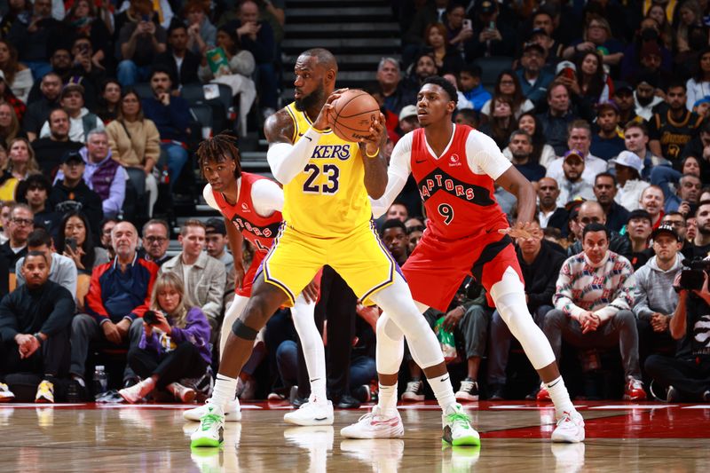 TORONTO, CANADA - NOVEMBER 1: LeBron James #23 of the Los Angeles Lakers handles the ball during the game against the Toronto Raptors on November 1, 2024 at the Scotiabank Arena in Toronto, Ontario, Canada.  NOTE TO USER: User expressly acknowledges and agrees that, by downloading and or using this Photograph, user is consenting to the terms and conditions of the Getty Images License Agreement.  Mandatory Copyright Notice: Copyright 2024 NBAE (Photo by Vaughn Ridley/NBAE via Getty Images)