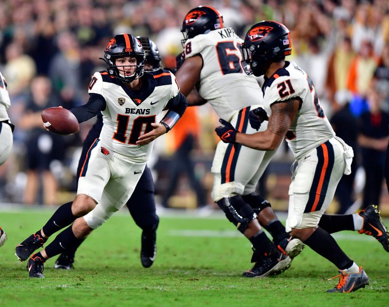 Sep 4, 2021; West Lafayette, Indiana, USA;  Oregon State Beavers quarterback Chance Nolan (10) hands the all off to Oregon State Beavers running back Trey Lowe (21) during the second half of the game at Ross-Ade Stadium. The Purdue Boilermakers defeated the Oregon State Beavers 30 to 21. Mandatory Credit: Marc Lebryk-USA TODAY Sports