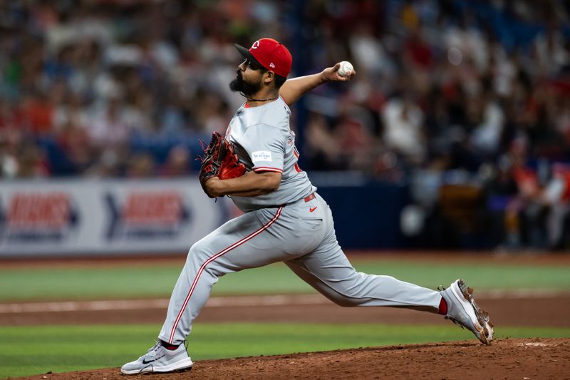 Jul 27, 2024; St. Petersburg, Florida, USA; Cincinnati Reds pitcher Tony Santillan (64) pitches the ball against the Tampa Bay Rays during the fifth inning at Tropicana Field. Mandatory Credit: Matt Pendleton-USA TODAY Sports