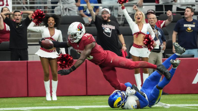 Arizona Cardinals wide receiver Marvin Harrison Jr. (18) makes a touchdown catch against the Los Angeles Rams during the first half of an NFL football game, Sunday, Sept. 15, 2024, in Glendale, Ariz. (AP Photo/Rick Scuteri)