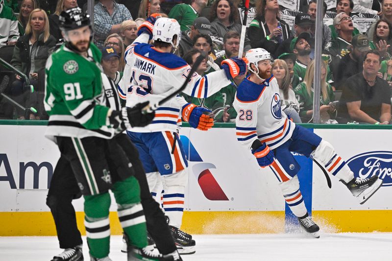 May 25, 2024; Dallas, Texas, USA; Edmonton Oilers center Mattias Janmark (13) and right wing Connor Brown (28) celebrates a goal scored by Brown against the Dallas Stars during the first period in game two of the Western Conference Final of the 2024 Stanley Cup Playoffs at American Airlines Center. Mandatory Credit: Jerome Miron-USA TODAY Sports