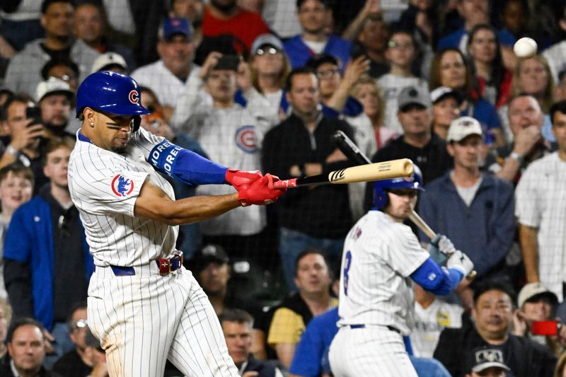 May 16, 2024; Chicago, Illinois, USA;  Chicago Cubs third baseman  Christopher Morel (5) hits an RBI sacrifice fly ball against the Pittsburgh Pirates during the eighth inning at Wrigley Field. Mandatory Credit: Matt Marton-USA TODAY Sports