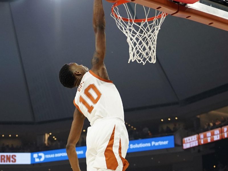 Mar 4, 2023; Austin, Texas, USA; Texas Longhorns guard Sir'Jabari Rice (10) dunks over Kansas Jayhawks guard Joseph Yesufu (1) during the first half at Moody Center. Mandatory Credit: Scott Wachter-USA TODAY Sports