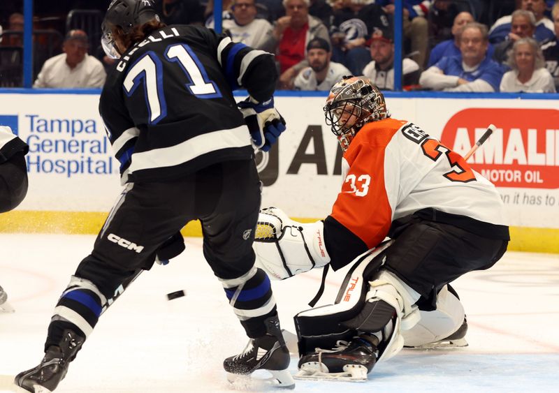 Mar 9, 2024; Tampa, Florida, USA; Philadelphia Flyers goaltender Samuel Ersson (33) looks at the puck as Tampa Bay Lightning center Anthony Cirelli (71) moves in during the first period at Amalie Arena. Mandatory Credit: Kim Klement Neitzel-USA TODAY Sports