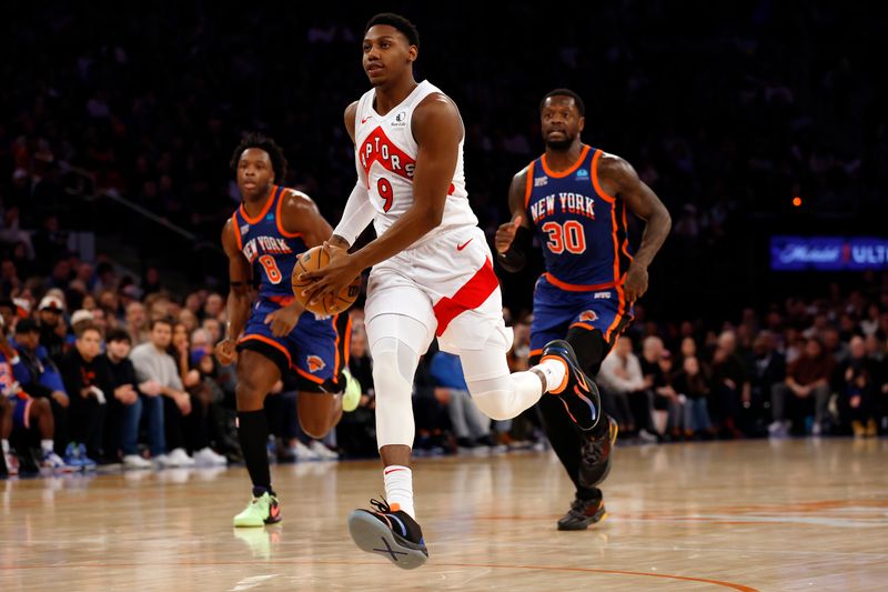 NEW YORK, NEW YORK - JANUARY 20: RJ Barrett #9 of the Toronto Raptors dribbles as OG Anunoby #8 and Julius Randle #30 of the New York Knicks defend during the second half at Madison Square Garden on January 20, 2024 in New York City. The Knicks won 126-120. NOTE TO USER: User expressly acknowledges and agrees that, by downloading and/or using this Photograph, user is consenting to the terms and conditions of the Getty Images License Agreement. (Photo by Sarah Stier/Getty Images)