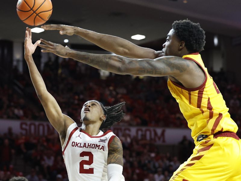 Jan 6, 2024; Norman, Oklahoma, USA; Oklahoma Sooners guard Javian McCollum (2) goes up for a lay up as Iowa State Cyclones forward Hason Ward (24) defends during the second half at Lloyd Noble Center. Mandatory Credit: Alonzo Adams-USA TODAY Sports