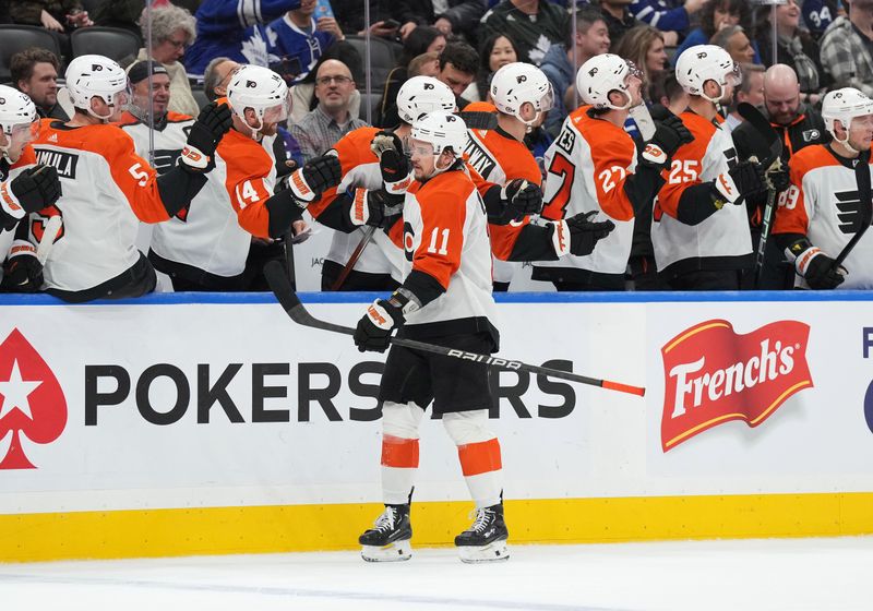 Feb 15, 2024; Toronto, Ontario, CAN; Philadelphia Flyers right wing Travis Konecny (11) celebrates with teammates after scoring a goal against the Toronto Maple Leafs during the third period at Scotiabank Arena. Mandatory Credit: Nick Turchiaro-USA TODAY Sports